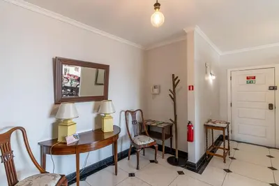 a room with a table and chairs and a mirror at Magnolia Apartment Luxury Apt Great views in Funchal