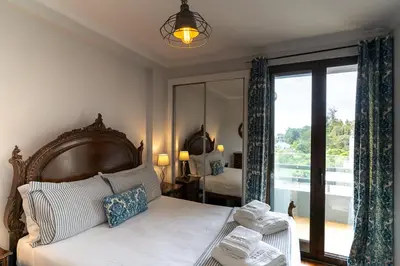 a bedroom with a bed and a large window at Magnolia Apartment Luxury Apt Great views in Funchal