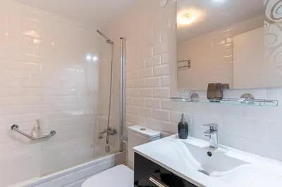 a bathroom with a sink and a toilet and a shower at Magnolia Apartment Luxury Apt Great views in Funchal