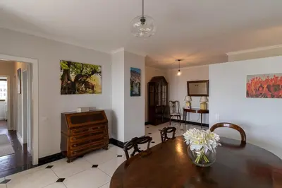 a living room with a wooden table and a desk at Magnolia Apartment Luxury Apt Great views in Funchal