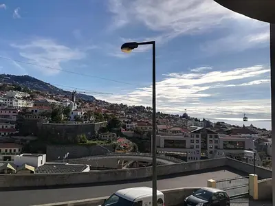 a street light with a view of a city at Apartment Bay Historic Center in Funchal