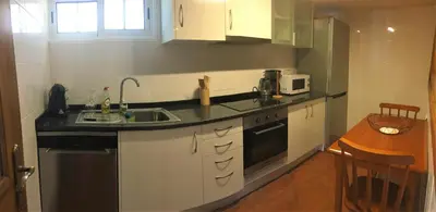 a small kitchen with a sink and a microwave at Casa dos Reis in Calheta