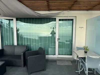 a patio with two chairs and a sliding glass door at Casa dos Reis in Calheta