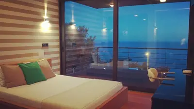a bedroom with a bed and a large window at Villa Cary in Funchal