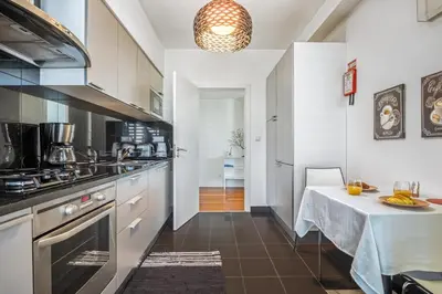 a kitchen with a table and a counter top at Apartamento Monumental - By WeHost Madeira in Funchal