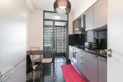 a kitchen with a table and a dining room at Apartamento Monumental - By WeHost Madeira in Funchal