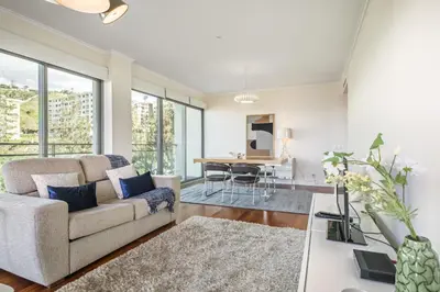 a living room with a couch and a table at Apartamento Monumental - By WeHost Madeira in Funchal