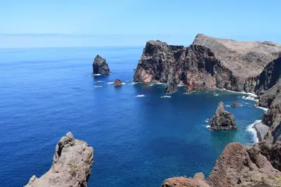 an island in the ocean with rocks in the water at Estacada Apartment in Machico