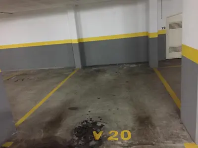 an empty parking garage with a yellow and white wall at Estacada Apartment in Machico
