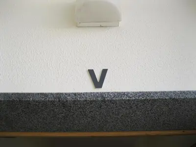 a letter v on the top of a mattress at Estacada Apartment in Machico