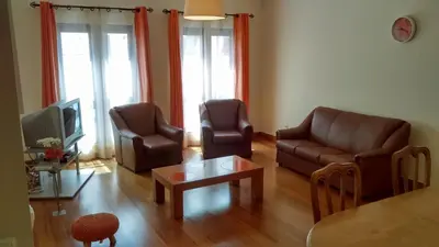 a living room with two chairs and a tv at Estacada Apartment in Machico