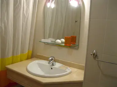 a bathroom with a sink and a mirror at Estacada Apartment in Machico