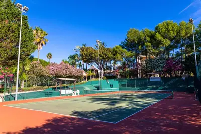 a tennis court with two tennis courts at Resort Fazenda Viegas in Lagos