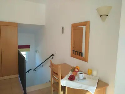 a room with a table and a mirror and a table and chair at Club House CVL in Luz