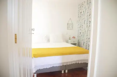 a bedroom with a bed with a yellow blanket at Irlandas Villa Funchal Seaside Villas in Funchal