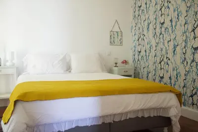 a bedroom with a bed with a yellow blanket at Irlandas Villa Funchal Seaside Villas in Funchal