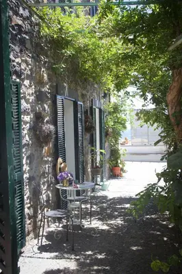 a table and chairs sitting outside of a building at Irlandas Villa Funchal Seaside Villas in Funchal