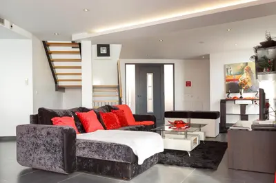 a living room with a couch and red pillows at Villa Maciel in Calheta