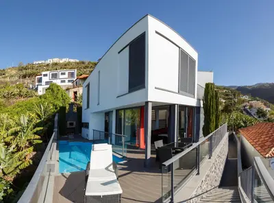 a house with a view of a swimming pool at Villa Maciel in Calheta