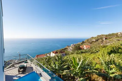 a view of the ocean from the balcony of a house at Villa Maciel in Calheta