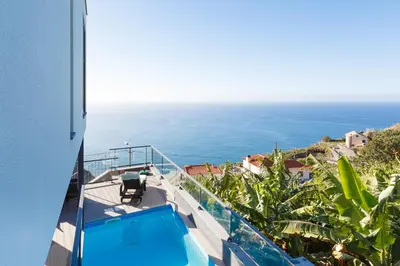 a view of the ocean from the balcony of a house at Villa Maciel in Calheta