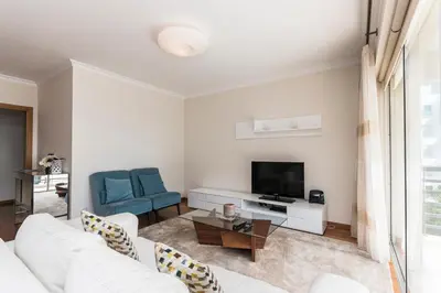 a living room with a white couch and a tv at Costa Sol IX by Madeira Holiday Rentals in Funchal