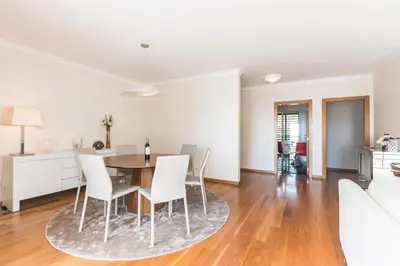 a dining room and living room with a table and chairs at Costa Sol IX by Madeira Holiday Rentals in Funchal