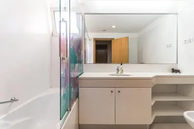 a bathroom with a sink and a tub and a mirror at Costa Sol IX by Madeira Holiday Rentals in Funchal
