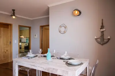 a dining room with a table with wine glasses at Peace Haven in Calheta