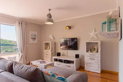 a living room with a couch and some wooden crates at Peace Haven in Calheta