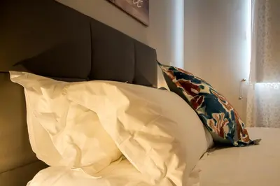 a bed with a headboard and two pillows on it at Peace Haven in Calheta