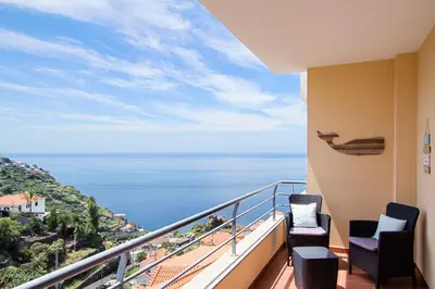 a balcony with a view of the ocean at Peace Haven in Calheta