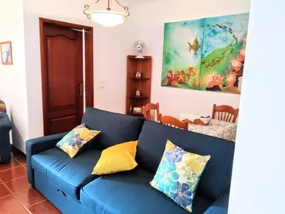 a blue couch with pillows in a living room at Refugio das Matas in Porto Santo