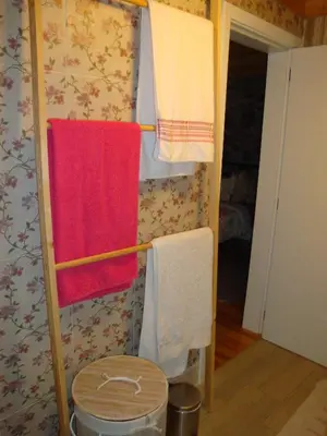 a bathroom with towels hanging on a wall at Vila Vinha in Arco da Calheta