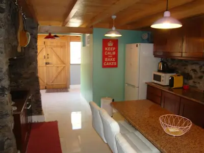 a kitchen with a counter and a refrigerator at Vila Vinha in Arco da Calheta
