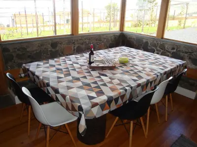 a checkered table with a bottle of wine on it at Vila Vinha in Arco da Calheta