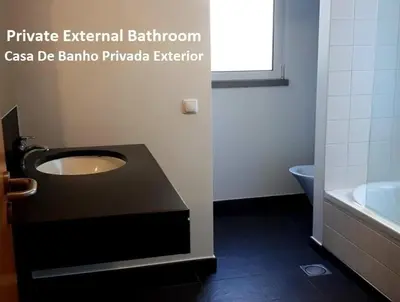 a bathroom with a sink and a toilet and a tub at Colinas do Sol in Funchal
