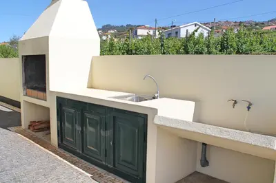 a kitchen with a sink on the side of a building at OurMadeira - Casa Vista Bela in Estreito da Calheta