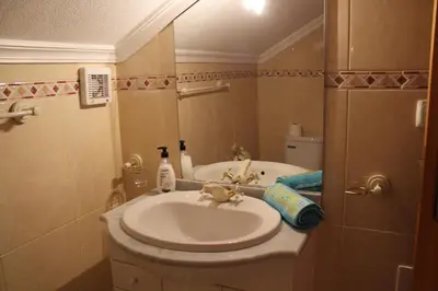 a bathroom with a sink and a shower with a mirror at OurMadeira - Casa Vista Bela in Estreito da Calheta