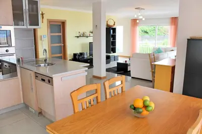 a kitchen with a table with a bowl of fruit on it at Tranquil villa with pool in Calheta ArcoView in Calheta