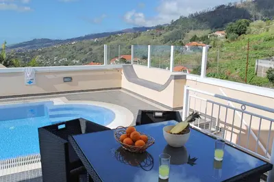 a bowl of fruit on a table next to a pool at Tranquil villa with pool in Calheta ArcoView in Calheta