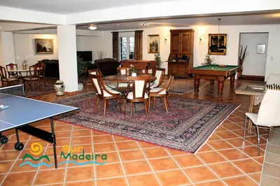 a living room with a table and a pool table at OurMadeira - Villa Luzia in Funchal