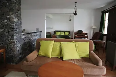 a living room with a couch with yellow pillows at Casa D'Avo Beatriz in Gaula