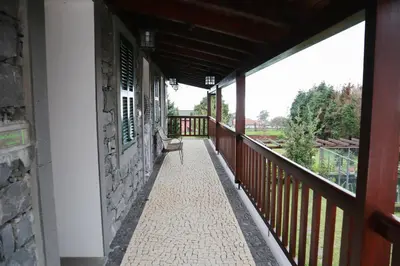 a balcony of a building with a bench on it at Casa D'Avo Beatriz in Gaula