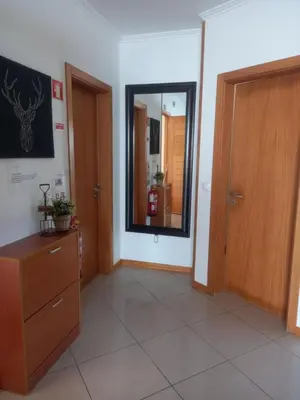 a room with a mirror and a dresser and a door at Vilas Horizonte in Porto Santo