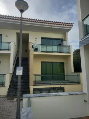 a house with a balcony and a street light at Vilas Horizonte in Porto Santo