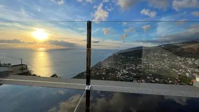 a view of the ocean from the edge of a building at Maison Blanche in Arco da Calheta