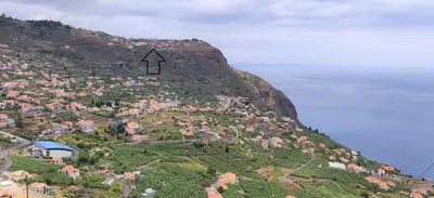 an arrow on the side of a mountain at Maison Blanche in Arco da Calheta