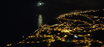 an aerial view of a city at night at Maison Blanche in Arco da Calheta