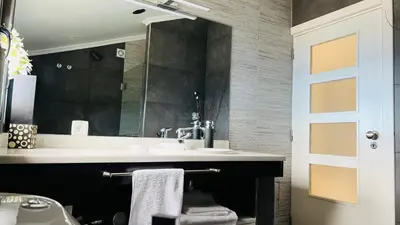 a bathroom with a sink and a mirror at Maison Blanche in Arco da Calheta